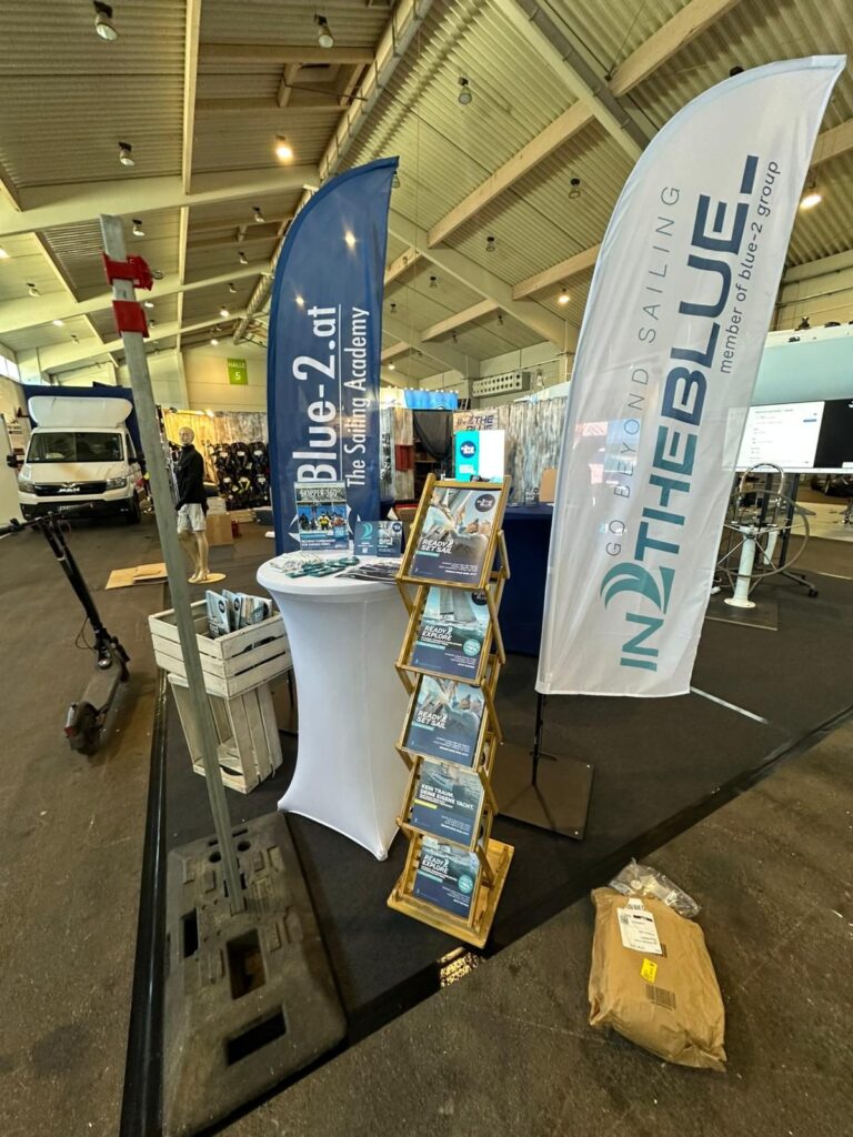 Brochure stand and beach flags at the IN2THEBLUE booth at Boot Tulln