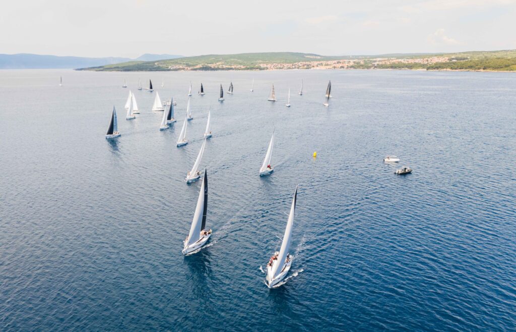 Aerial view of a regatta fleet of one-design yachts off Punat
