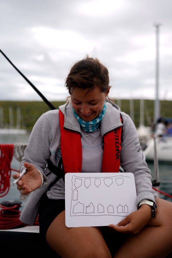 Participant holds up a sketch during the theory session on board