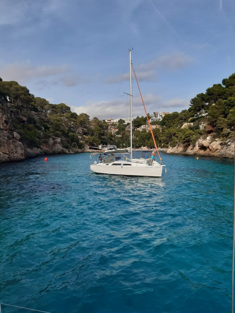 Sailing yacht at anchor in a bay with turquoise water